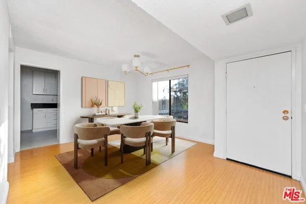 a view of a livingroom with dining room and wooden floor