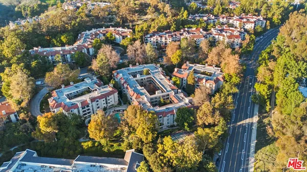 an aerial view of residential houses with outdoor space