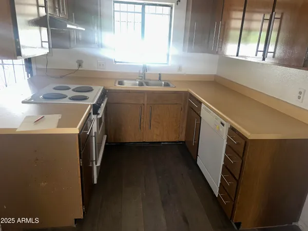 a kitchen with a sink stove and cabinets