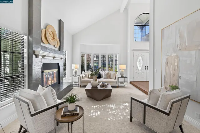 a living room with furniture a fireplace and decor