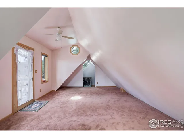 a bedroom with a bed a window and a television