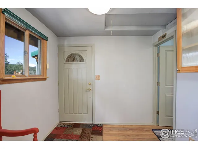 a living room with lots of furniture and view of kitchen