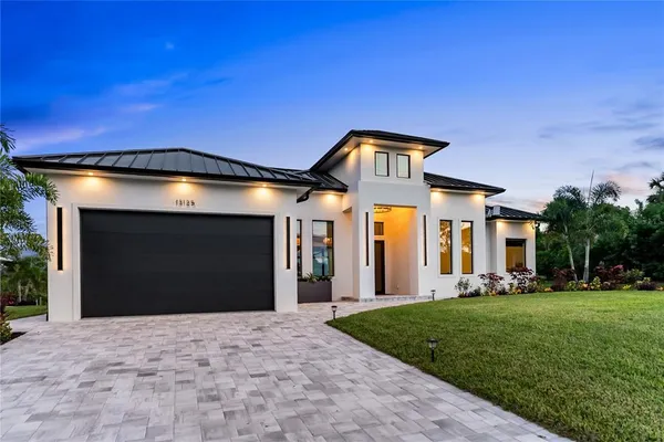 a front view of a house with a yard and garage