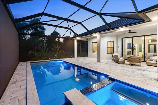 a view of a house with backyard and sitting area