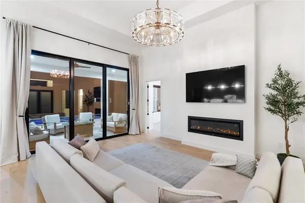 a living room with furniture and a chandelier