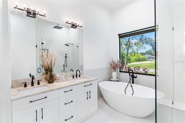 a large kitchen with kitchen island a large counter top space a sink stainless steel appliances and cabinets