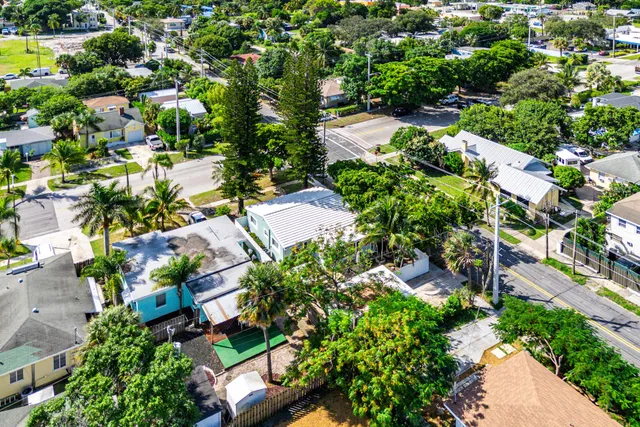 an aerial view of residential house with outdoor space and trees all around