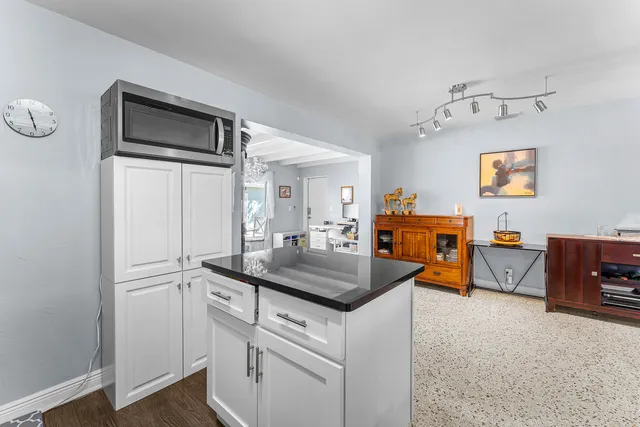 a kitchen with stainless steel appliances granite countertop a sink and a refrigerator