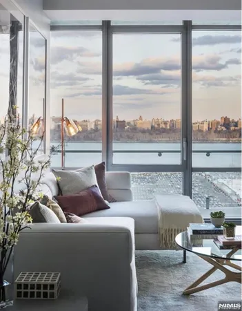 a living room with couch and a large window