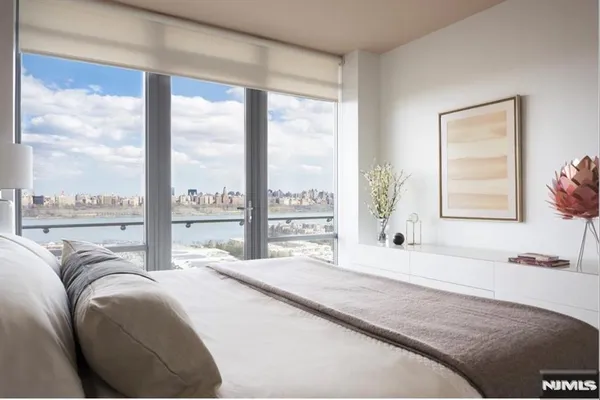 a bedroom with a large bed and a large window