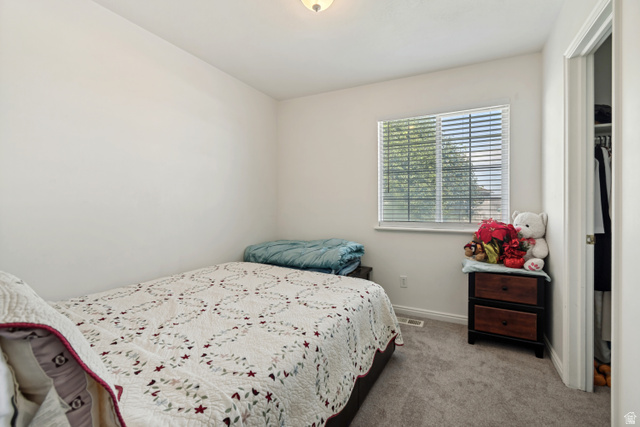 254 North 700 East Santaquin, UT 84655 - Photo 8 of 15 Bedroom featuring neutral wall paint, gray carpeting, a window with blinds, and an adjacent closet