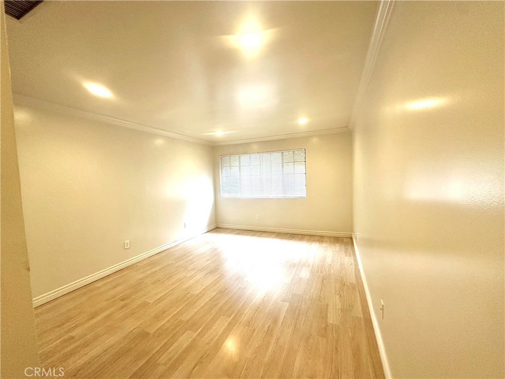 9356 19th Street, Unit A Rancho Cucamonga, CA 91701 - Photo 13 of 23 a view of empty room with wooden floor