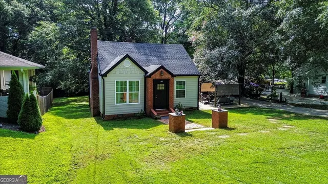 a backyard of a house with yard and outdoor seating