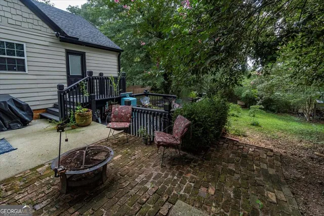 a balcony with wooden floor and potted plants
