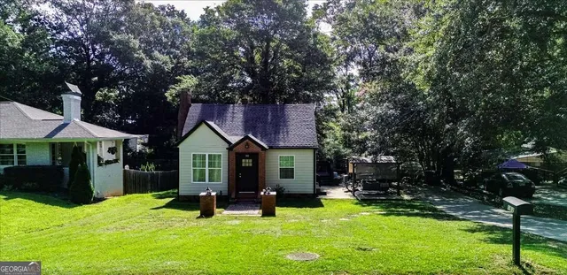 a view of a house with a yard porch and sitting area