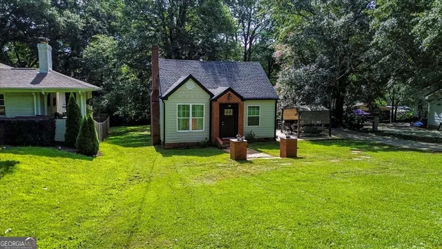 a view of a house with a yard patio and fire pit