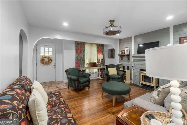a living room with furniture and a chandelier