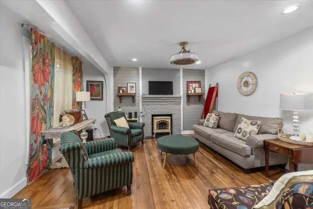 a living room with furniture a fireplace and a flat screen tv
