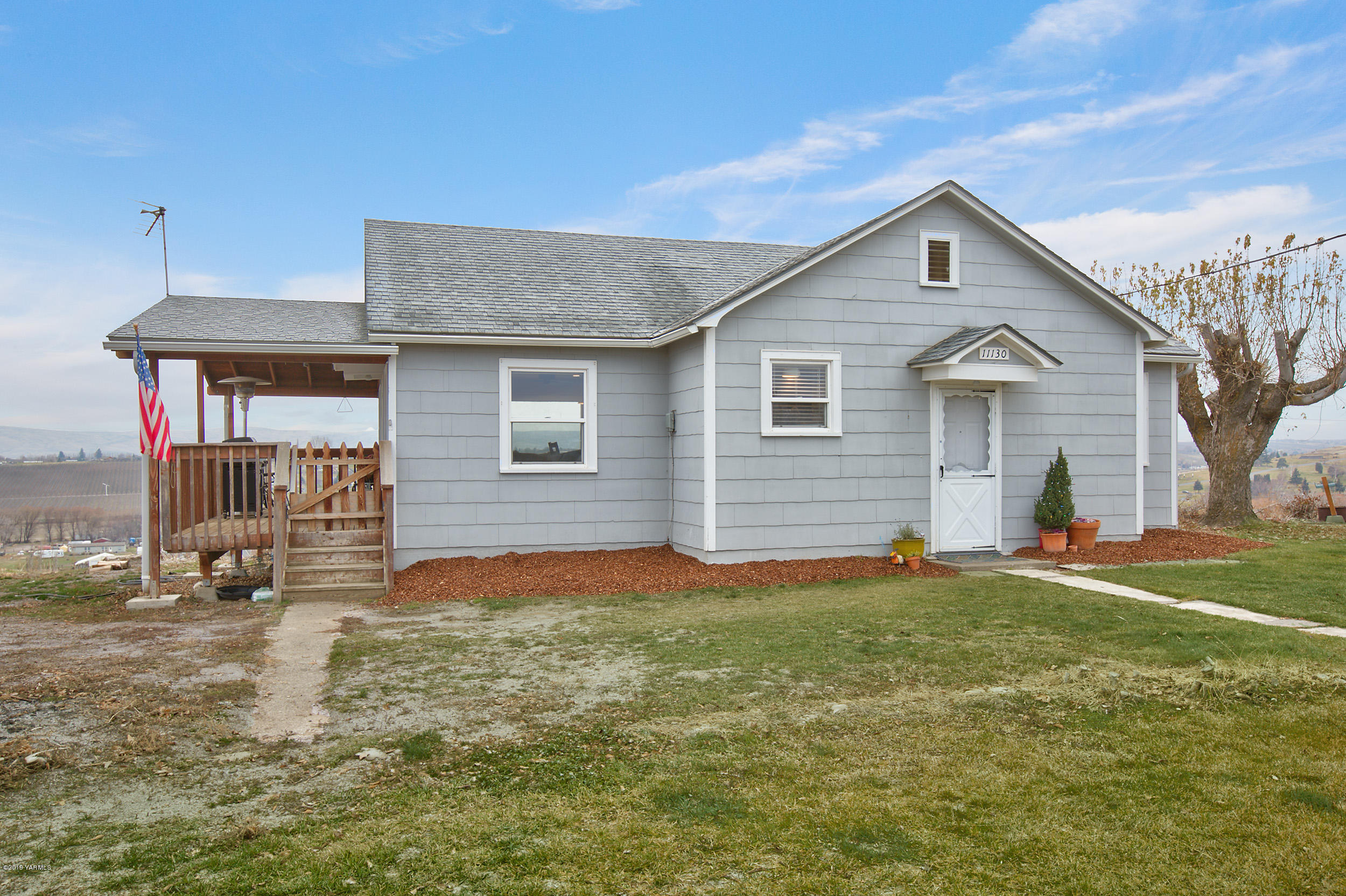 11130 Estes Road Yakima, WA 98908 - Photo 1 of 16 a view of a house with a yard and garage