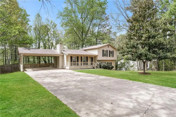 a front view of a house with a garden