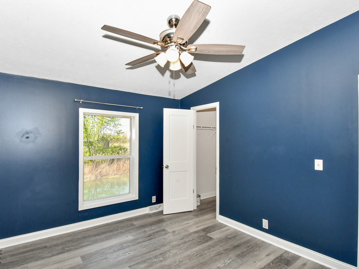 18530 West 3000N Road Reddick, IL 60961 - Photo 28 of 40 an empty room with wooden floor fan and windows