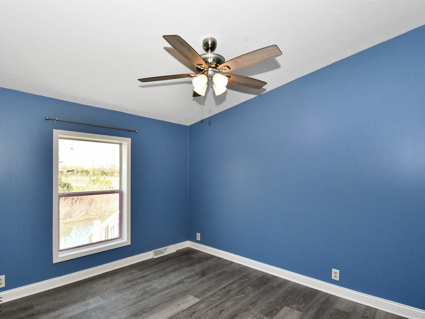 18530 West 3000N Road Reddick, IL 60961 - Photo 29 of 40 an empty room with a window and a ceiling fan