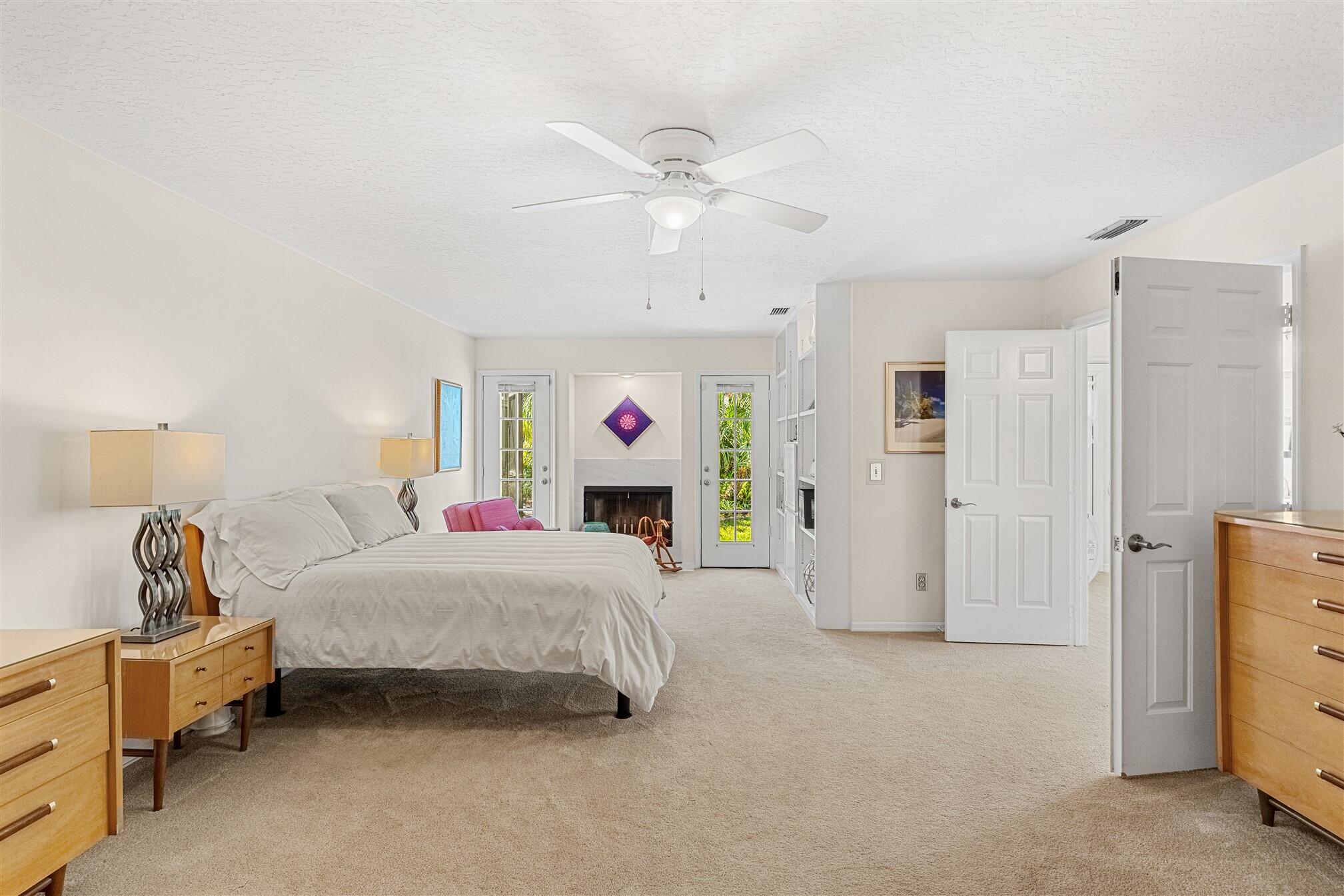 3660 Brennan Drive Melbourne, FL 32934 - Photo 24 of 71 a bedroom with a bed and a chandelier
