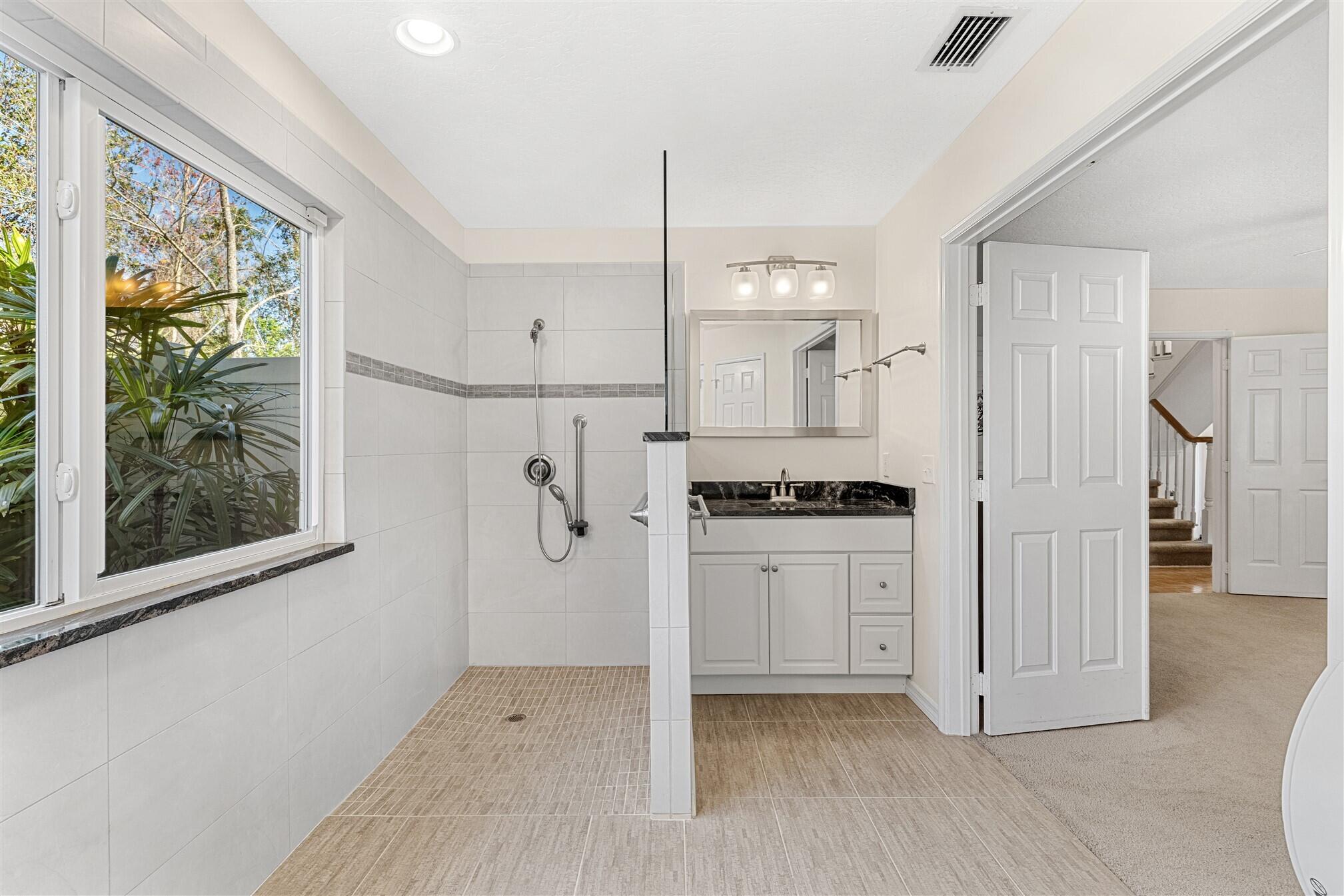 3660 Brennan Drive Melbourne, FL 32934 - Photo 26 of 71 a kitchen with white cabinets and a stove