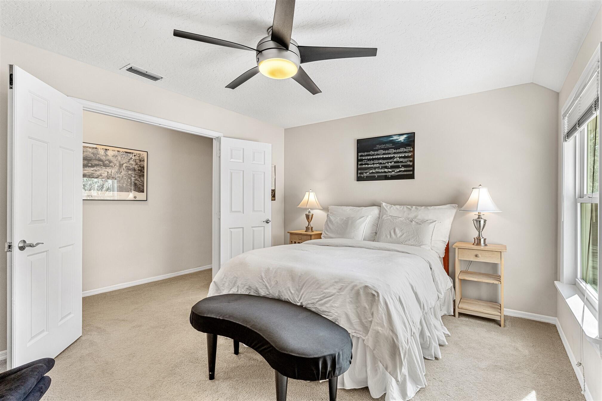 3660 Brennan Drive Melbourne, FL 32934 - Photo 36 of 71 a bedroom with a bed and a chandelier