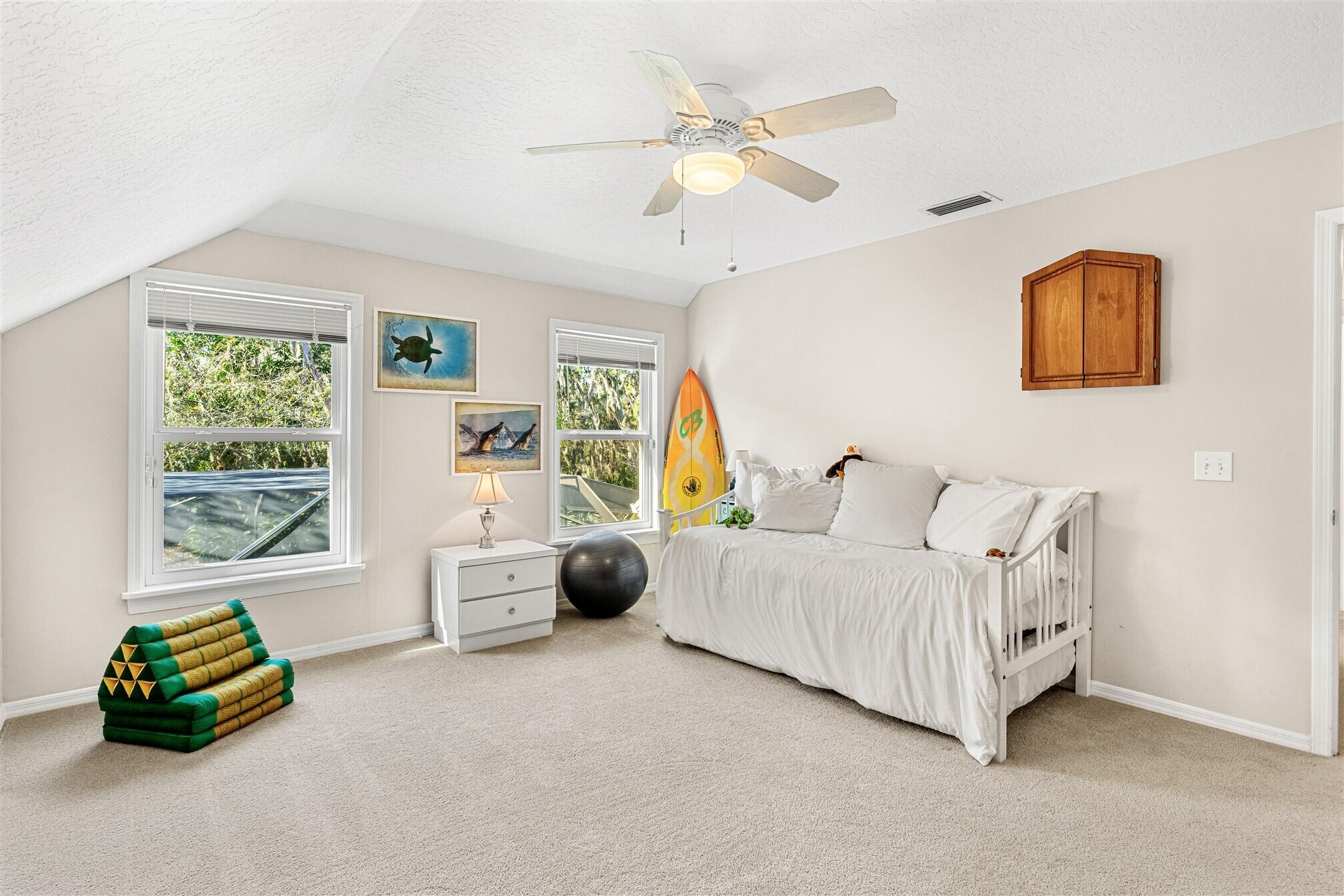 3660 Brennan Drive Melbourne, FL 32934 - Photo 39 of 71 a bedroom with a bed and a couch