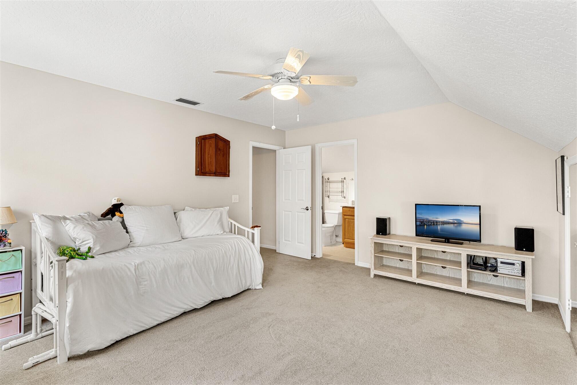 3660 Brennan Drive Melbourne, FL 32934 - Photo 40 of 71 a living room with furniture and a flat screen tv