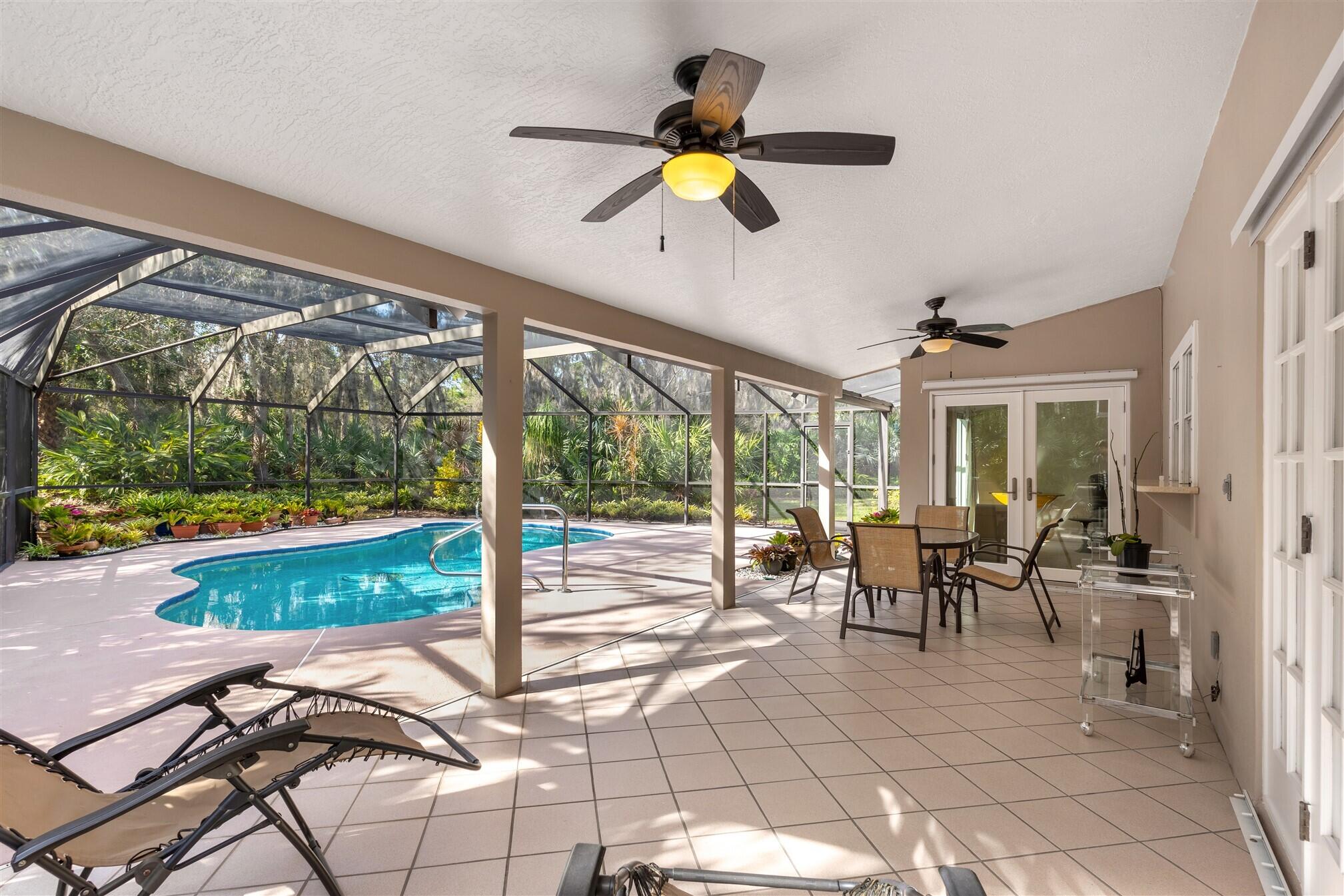 3660 Brennan Drive Melbourne, FL 32934 - Photo 4 of 71 a view of a dining room with furniture water view and a floor to ceiling window