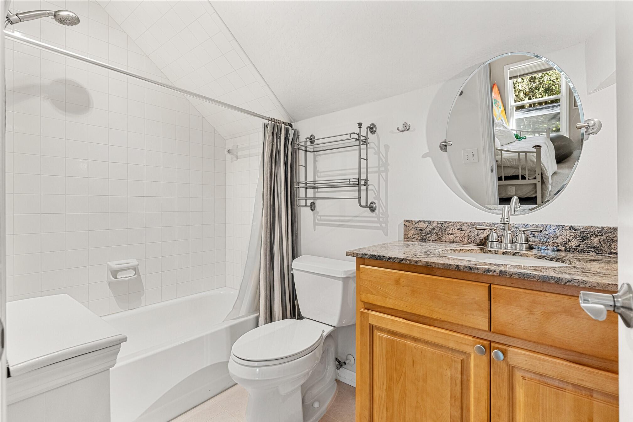 3660 Brennan Drive Melbourne, FL 32934 - Photo 41 of 71 a bathroom with a granite countertop sink toilet and shower