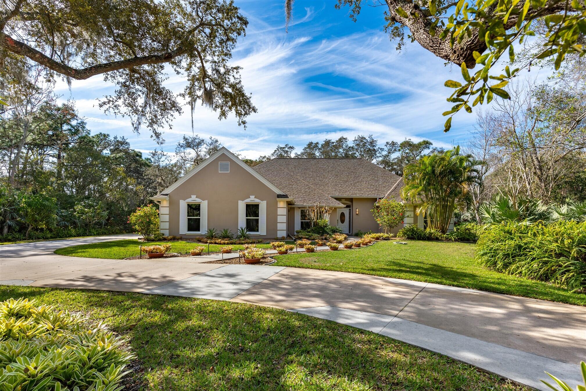 3660 Brennan Drive Melbourne, FL 32934 - Photo 5 of 71 a front view of a house with a yard and trees
