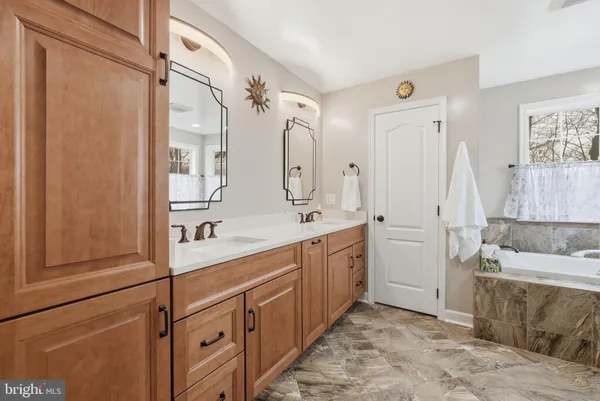 a spacious bathroom with a double vanity sink mirror and double