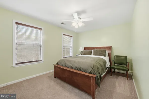 a bed sitting in a bedroom next to a window