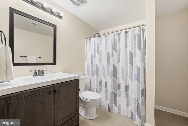 a bathroom with a toilet a sink and a mirror