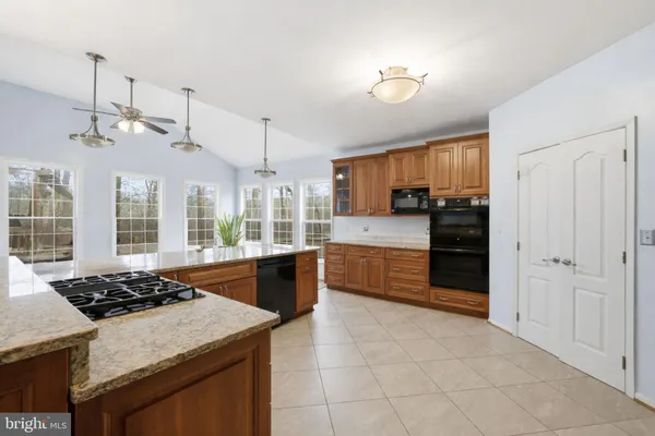 a kitchen with stainless steel appliances granite countertop a stove and a sink