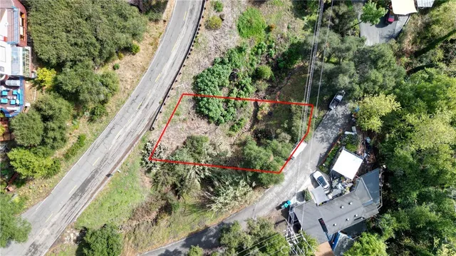 an aerial view of a house with a yard and garden
