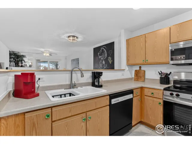 a kitchen with stainless steel appliances granite countertop a sink dishwasher stove and cabinets