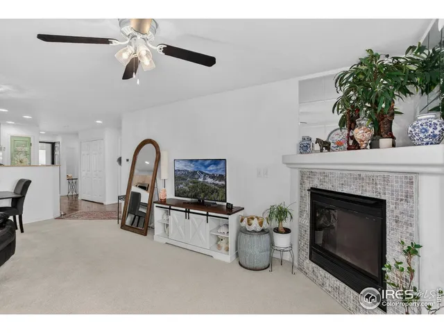 a living room with furniture a fireplace and a potted plant