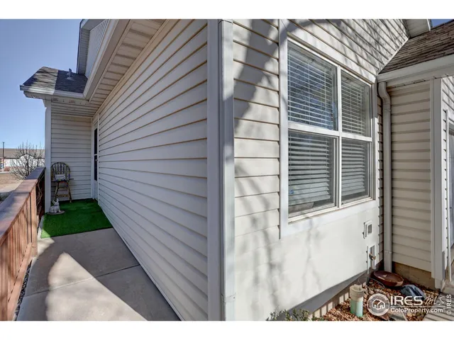 a view of a house with a yard and wooden fence
