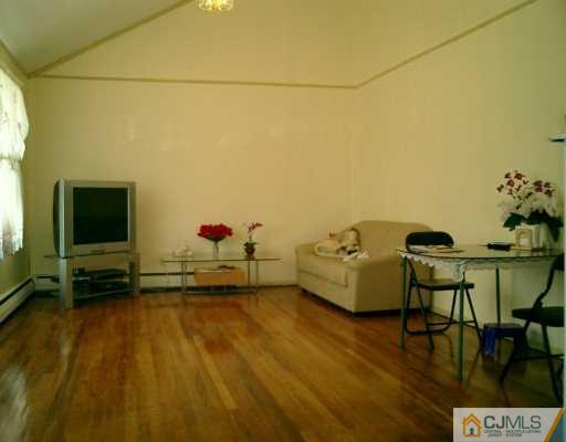 35 Sims Road Edison, NJ 08817 - Photo 2 of 4 a living room with furniture and a flat screen tv