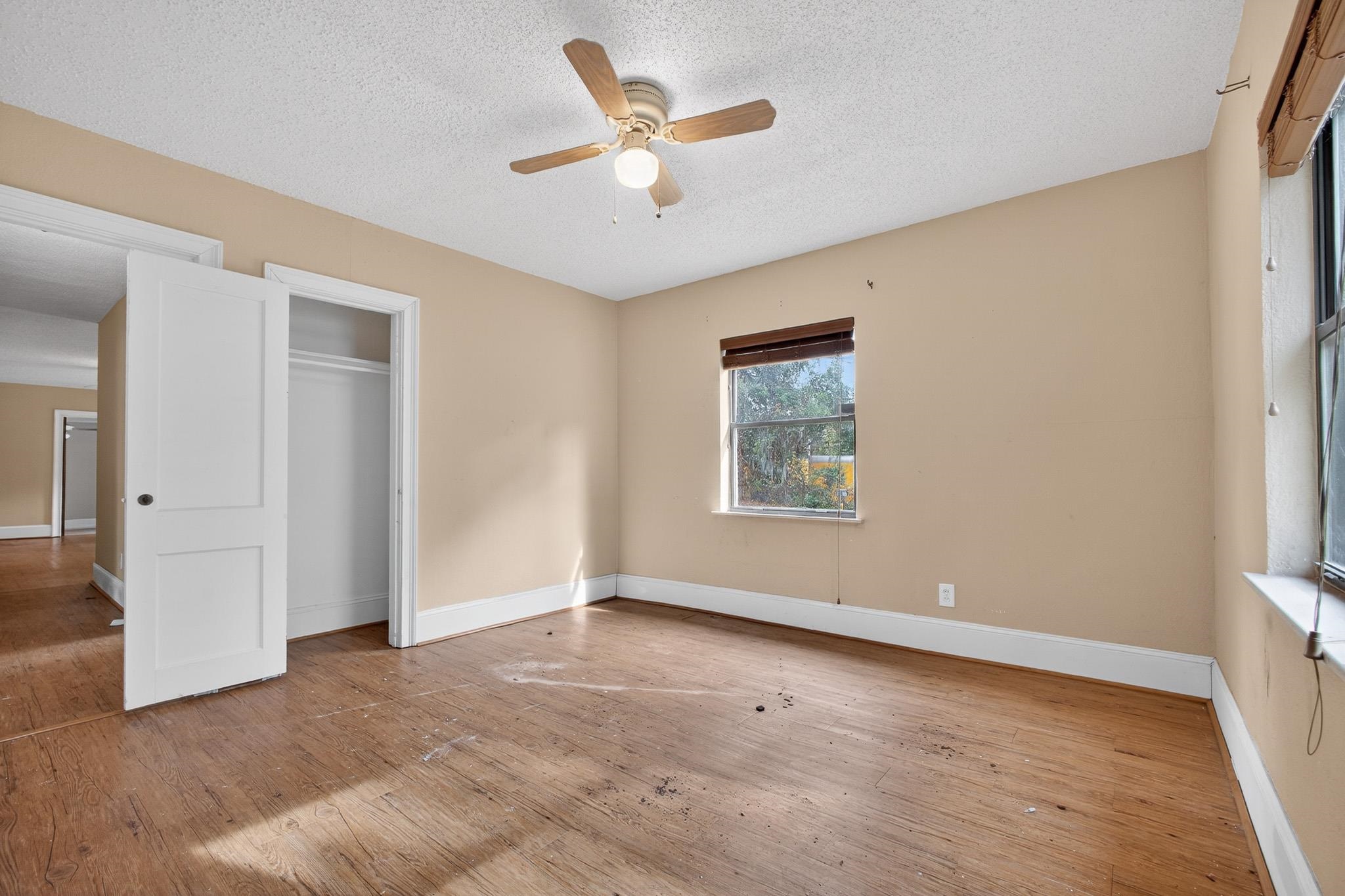 2907 North 5th Street St. Augustine, FL 32084 - Photo 16 of 71 Unfurnished bedroom featuring a textured ceiling, hardwood / wood-style flooring, ceiling fan, and a closet