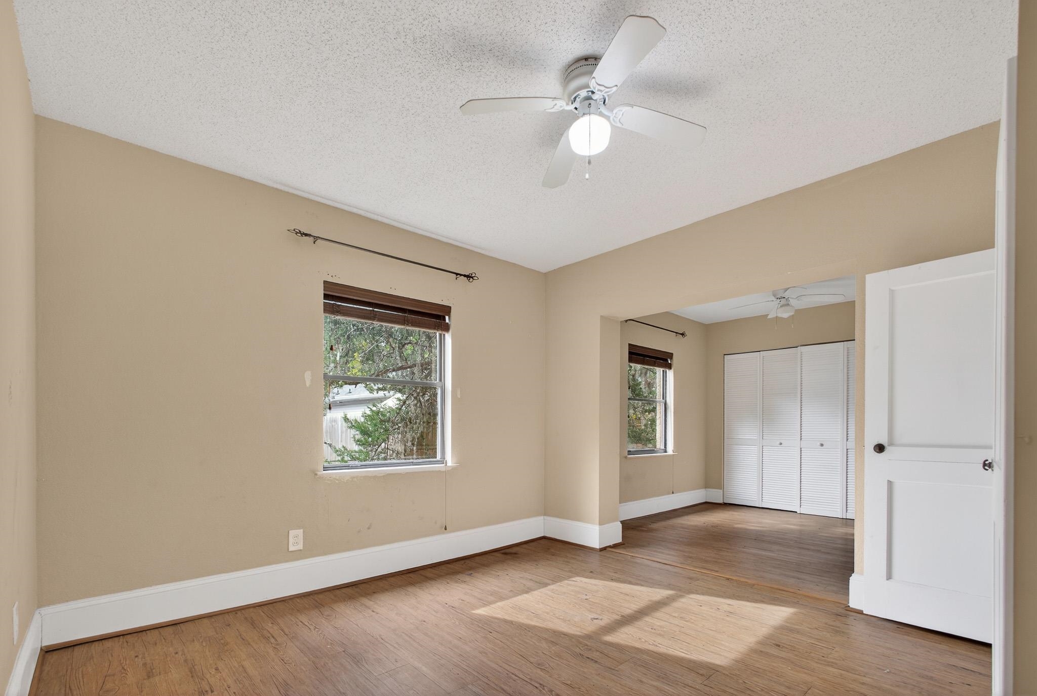 2907 North 5th Street St. Augustine, FL 32084 - Photo 18 of 71 Unfurnished bedroom with a ceiling fan, a closet, light wood-style flooring, and a textured ceiling