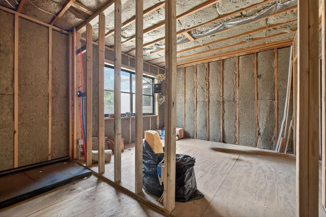 a view of a hallway with wooden floor and closet
