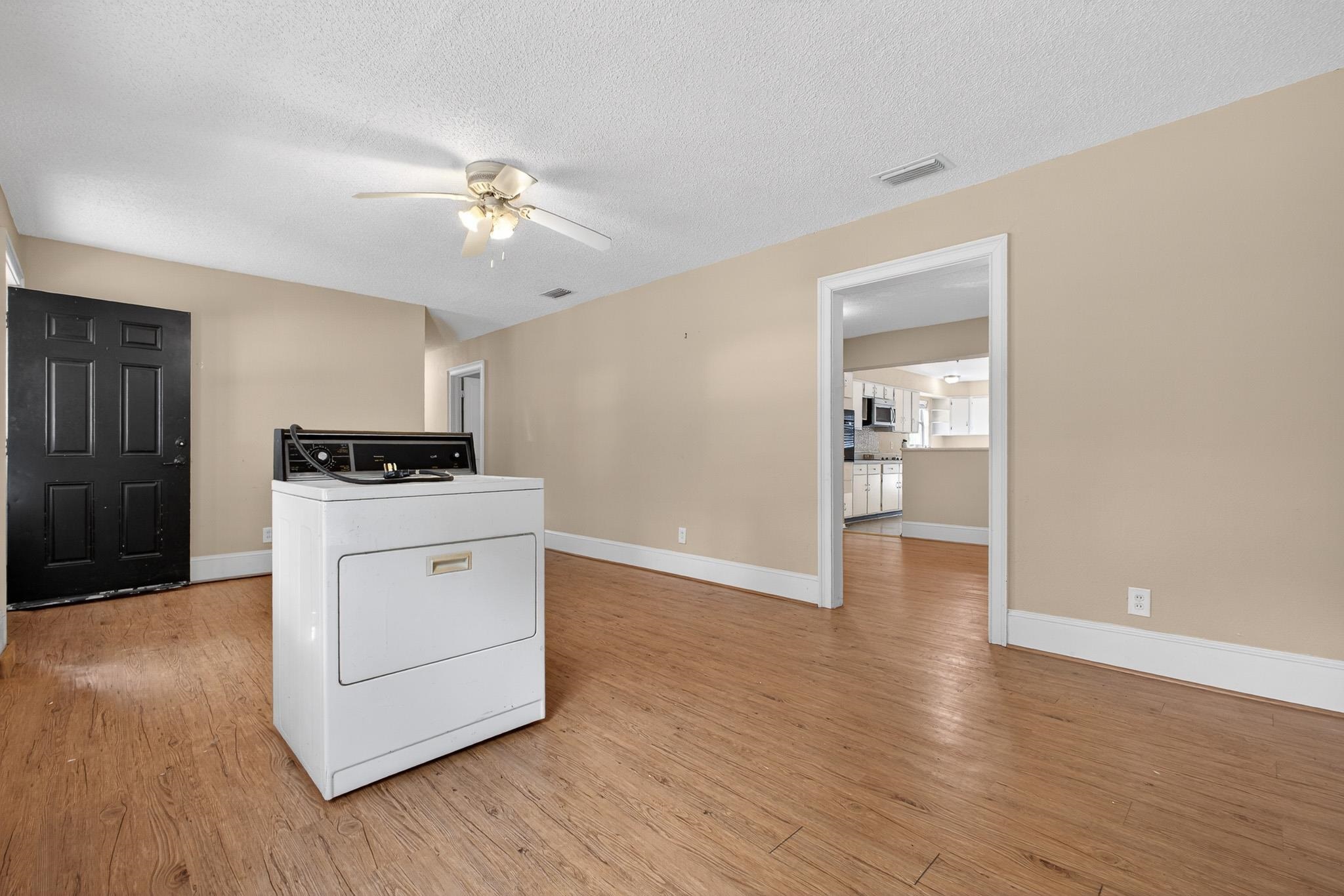 2907 North 5th Street St. Augustine, FL 32084 - Photo 29 of 71 Laundry area featuring washer / clothes dryer, light wood finished floors, a textured ceiling, and ceiling fan