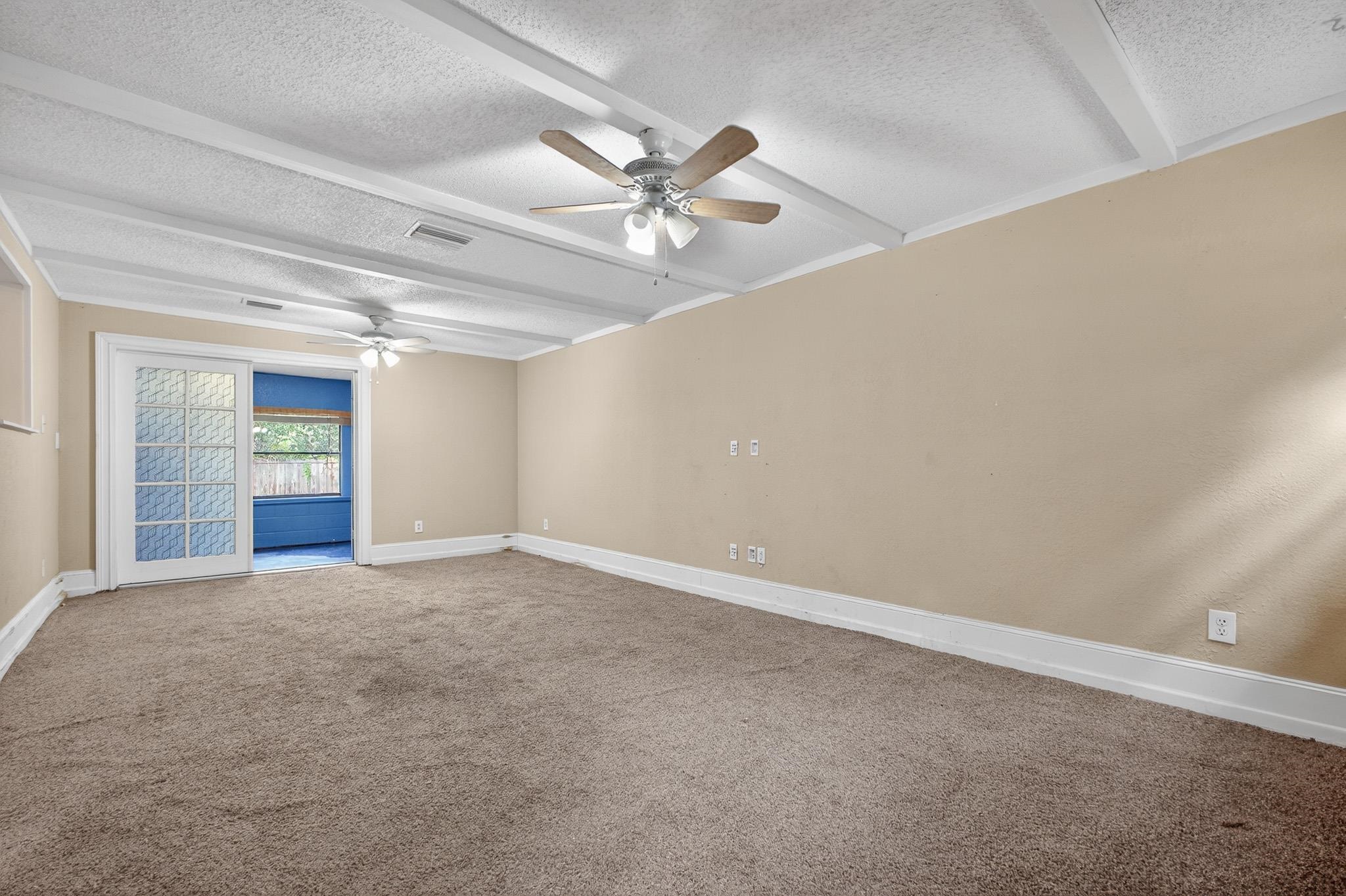 2907 North 5th Street St. Augustine, FL 32084 - Photo 41 of 71 Carpeted empty room featuring beamed ceiling, a textured ceiling, and a ceiling fan
