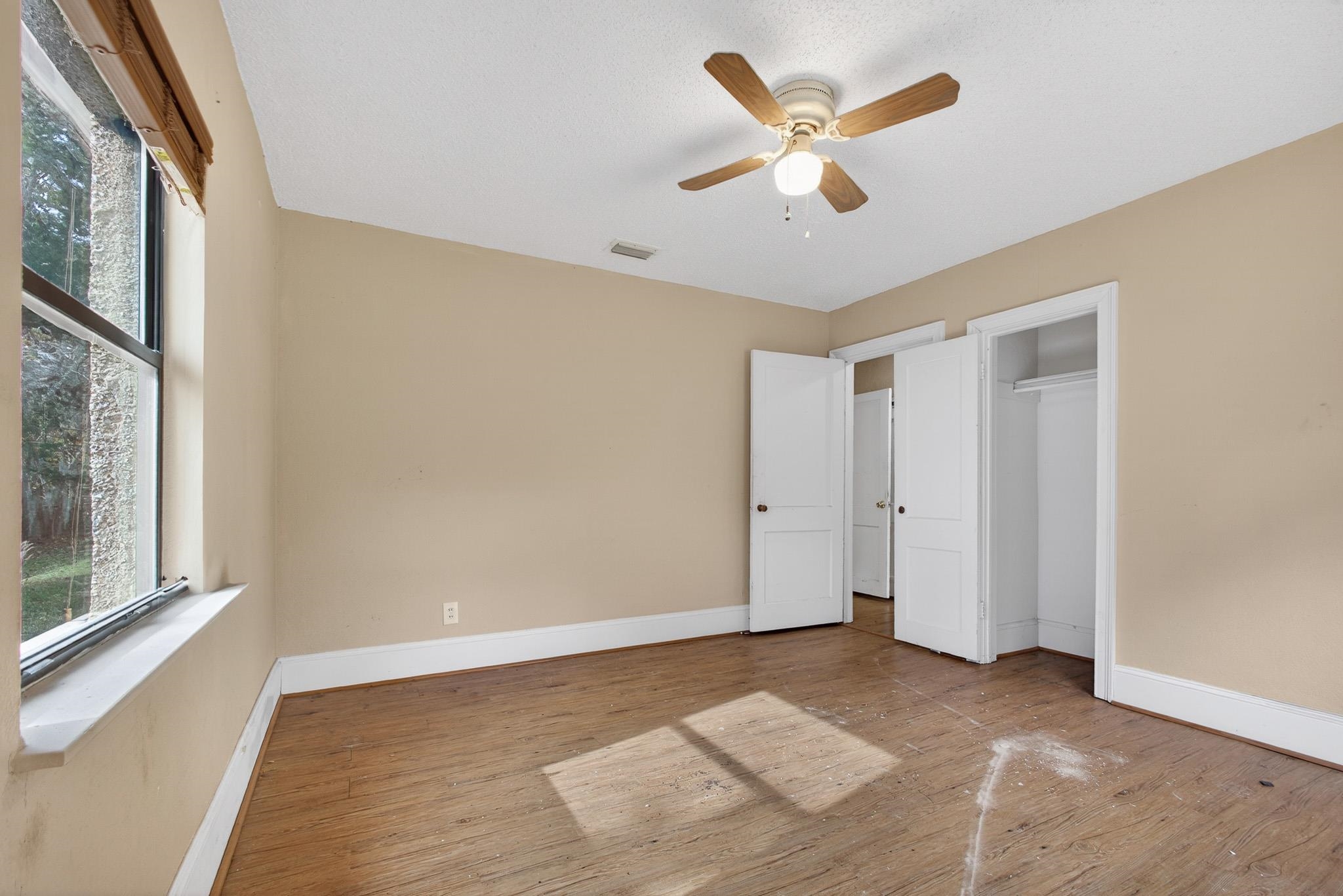 2907 North 5th Street St. Augustine, FL 32084 - Photo 47 of 71 Unfurnished bedroom with hardwood / wood-style flooring, multiple windows, a ceiling fan, and a closet