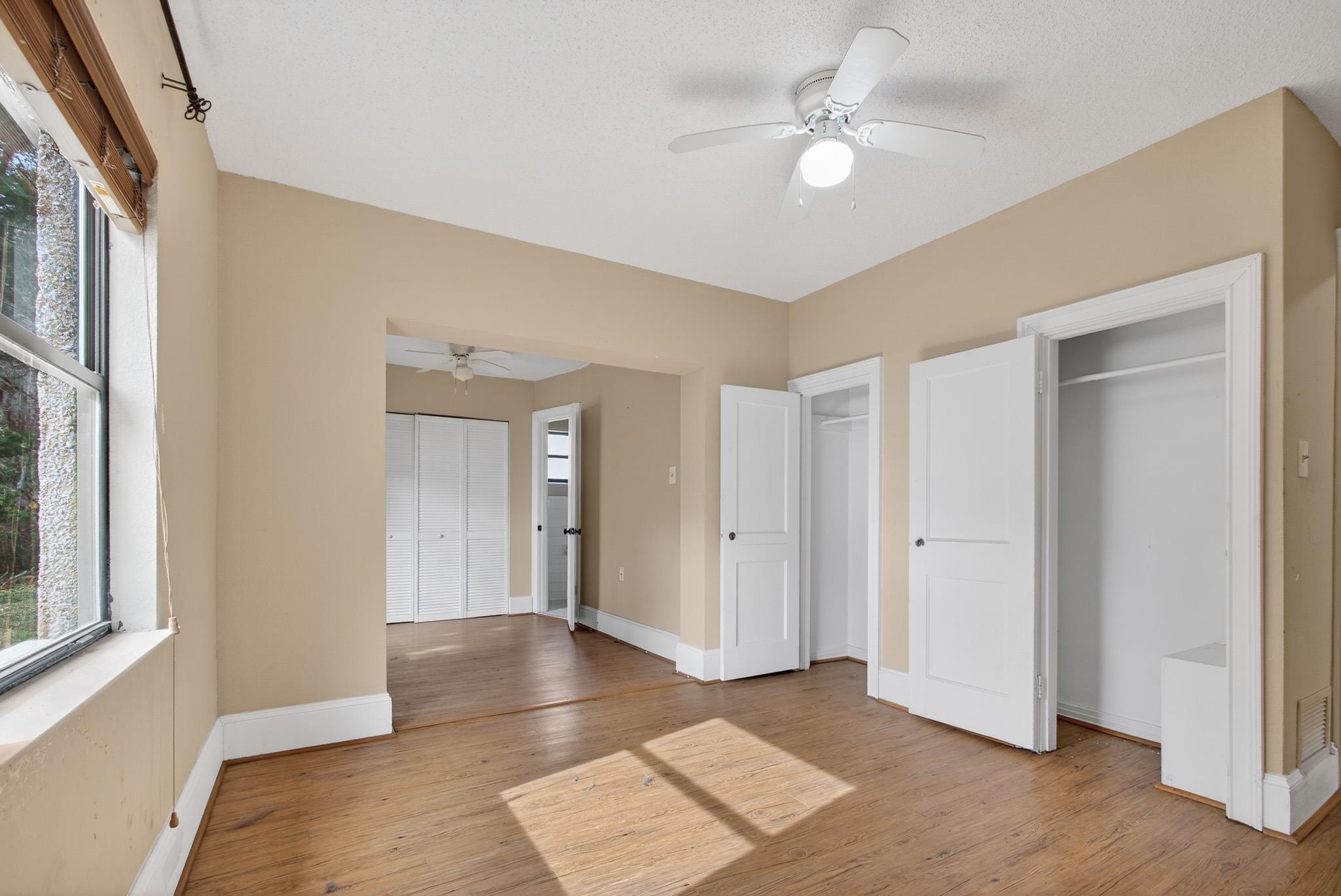 2907 North 5th Street St. Augustine, FL 32084 - Photo 48 of 71 Unfurnished bedroom with two closets, a ceiling fan, and light wood-type flooring
